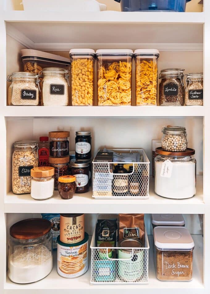 Organized kitchen pantry with clear storage containers and labeled jars - PantryPlace kitchen organization solutions for a fresh start