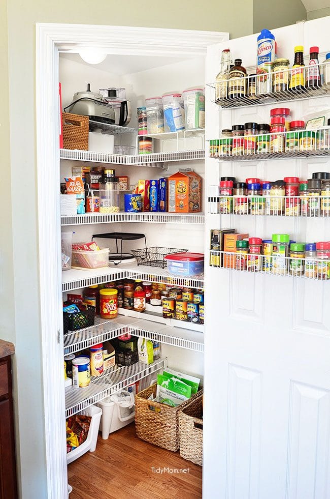 Organized pantry with premium storage solutions and kitchenware, featuring warm natural lighting and functional home organization design